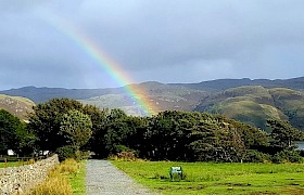 Rainbow over the woodland at Lochbuie